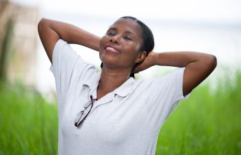 Relaxed cheerful Afro-American woman enjoying time outdoors.